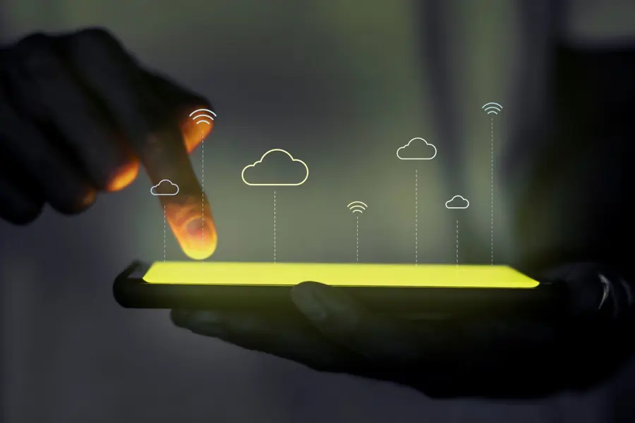Glowing screen with cloud icons above
