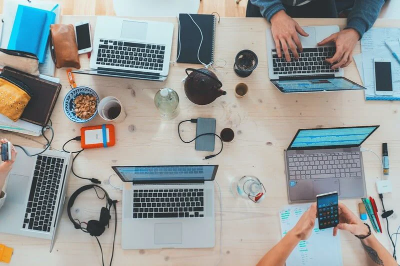 People working with equipment on desk