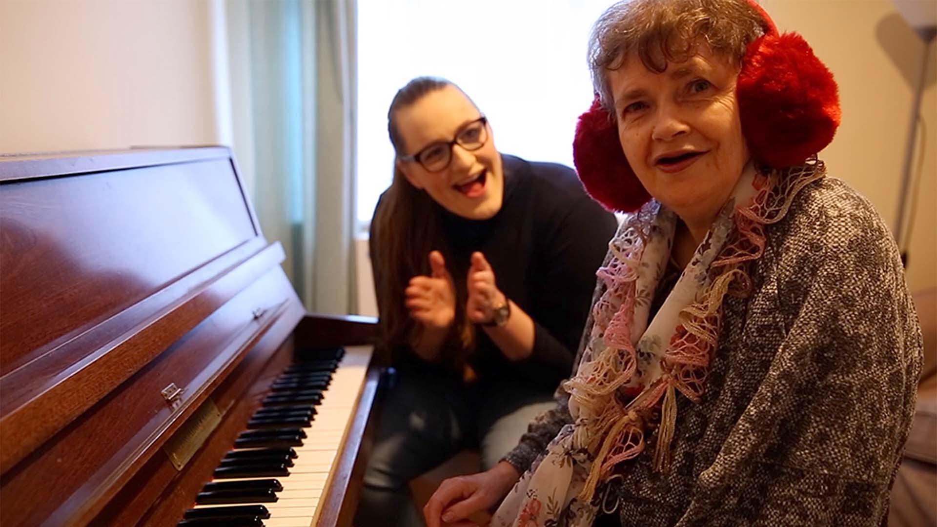 Two women sat at piano 