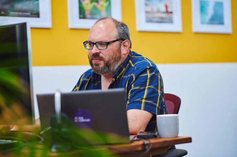 Tom Passmore sat at his desk working