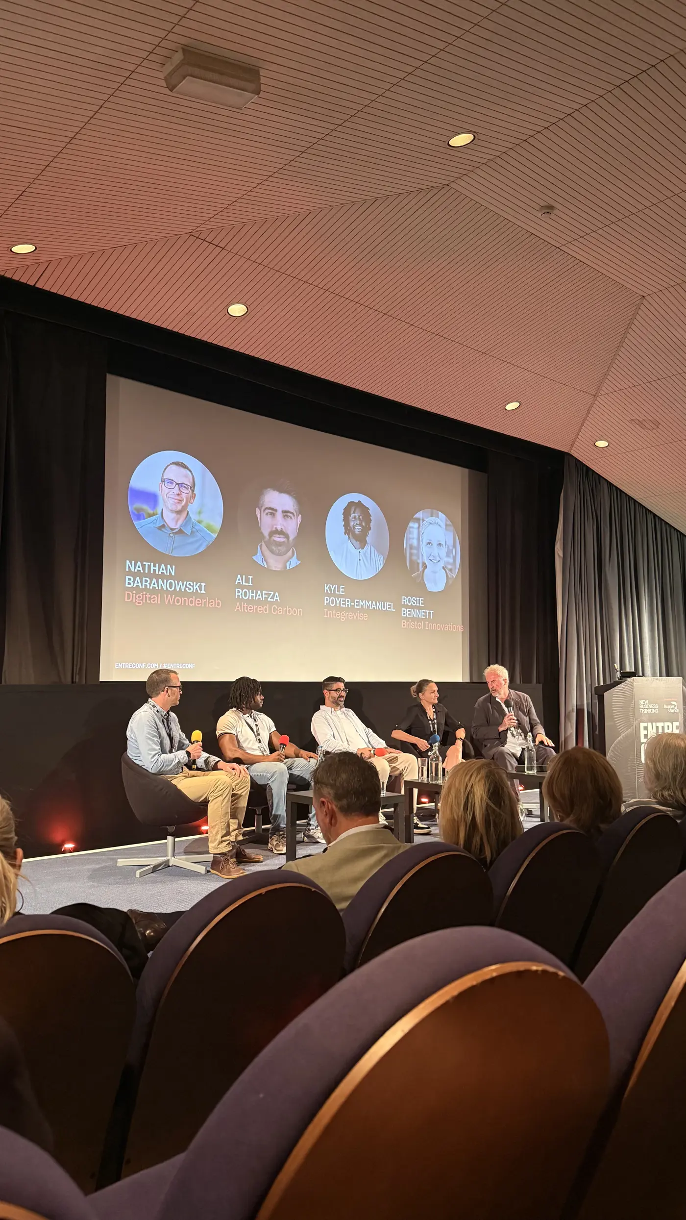 Image of panel at EntreConf 2025 sat on stage discussing AI