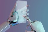Robot using touchscreen mobile phone - symbolising the need for AI systems to have a human touch.
