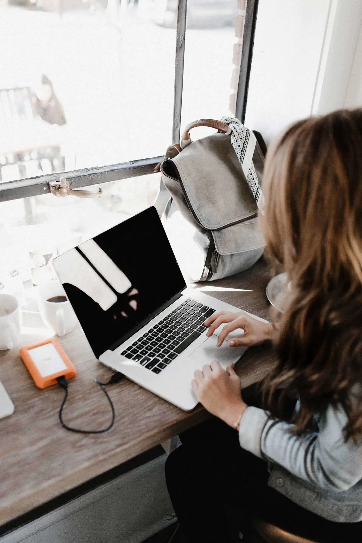 Woman working on laptop at desk