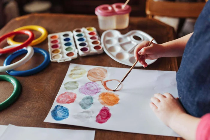 Child painting with brush on paper