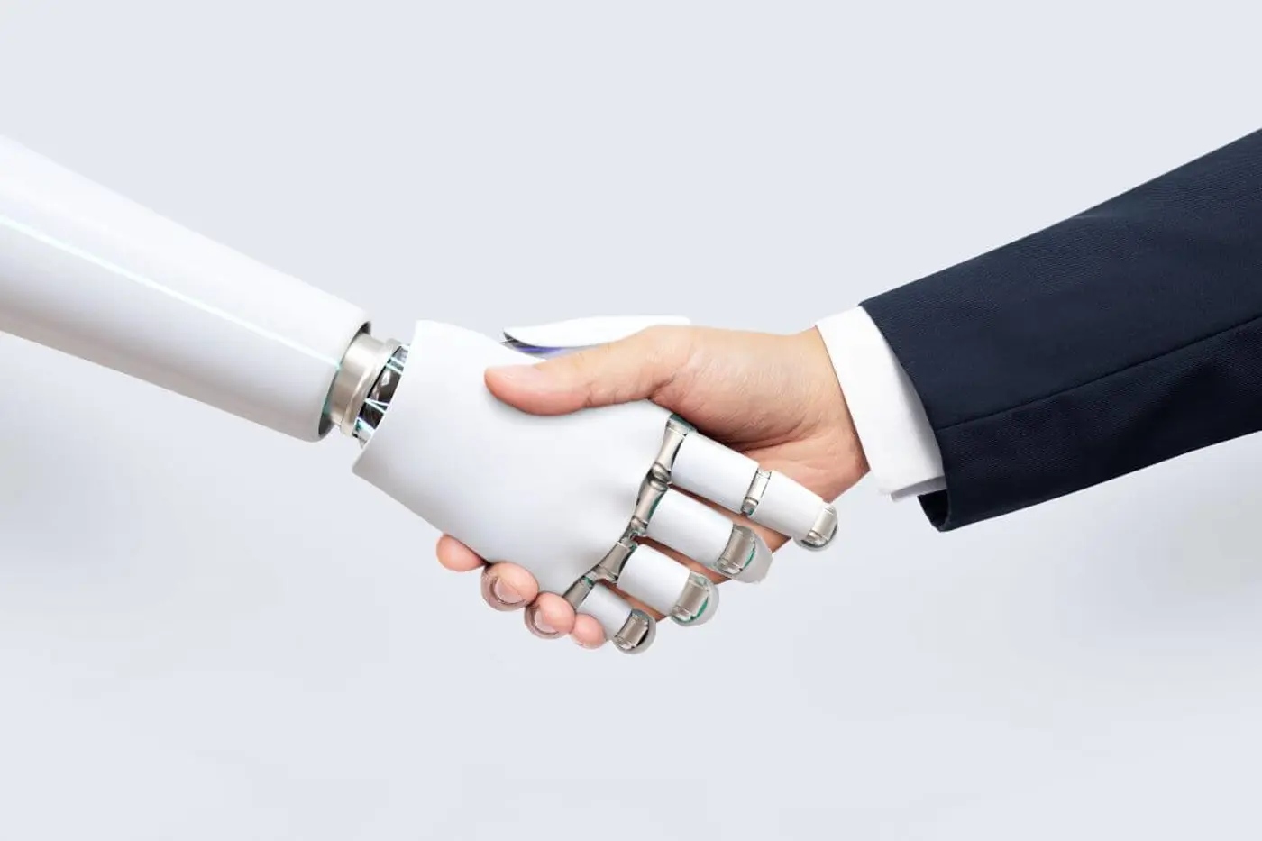 Robot and man shaking hands to visualise Digital Transformation