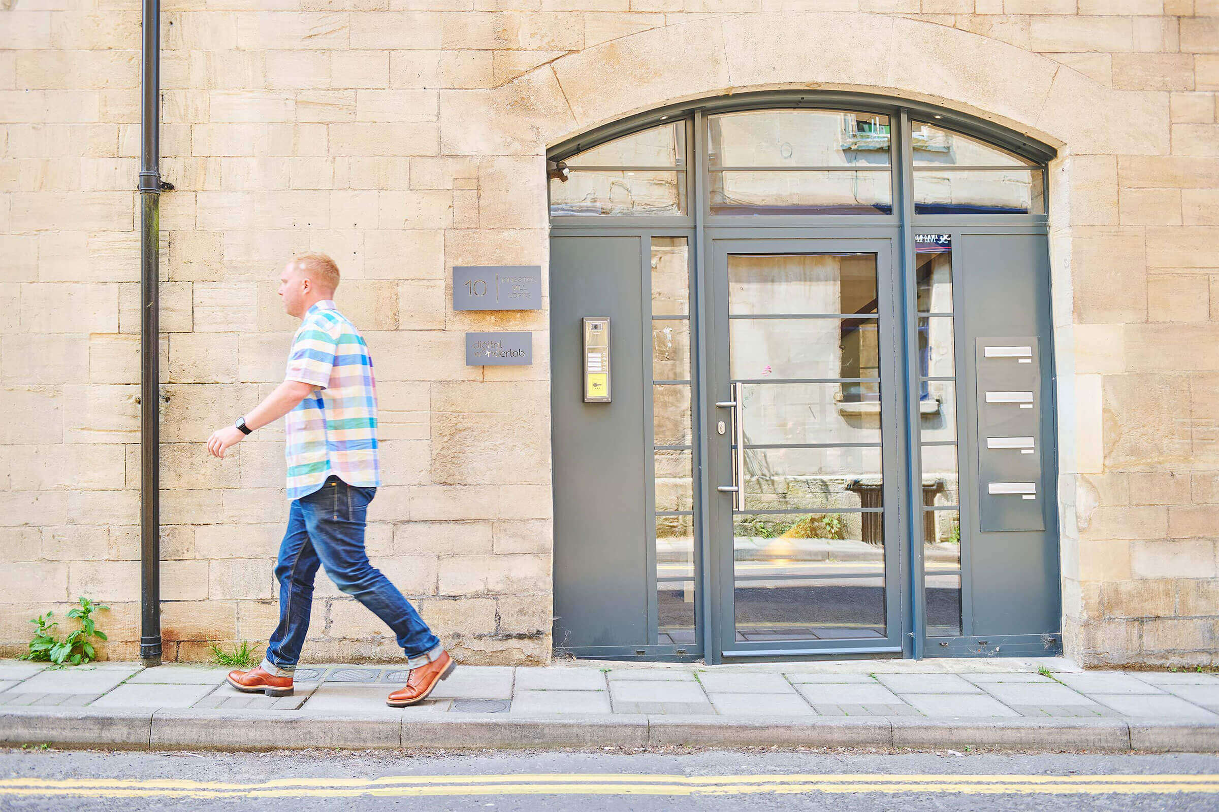 Team member walking past the front door of the office