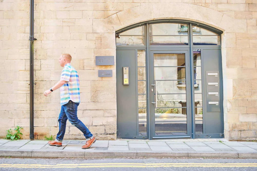 Team member walking past the front door of the office