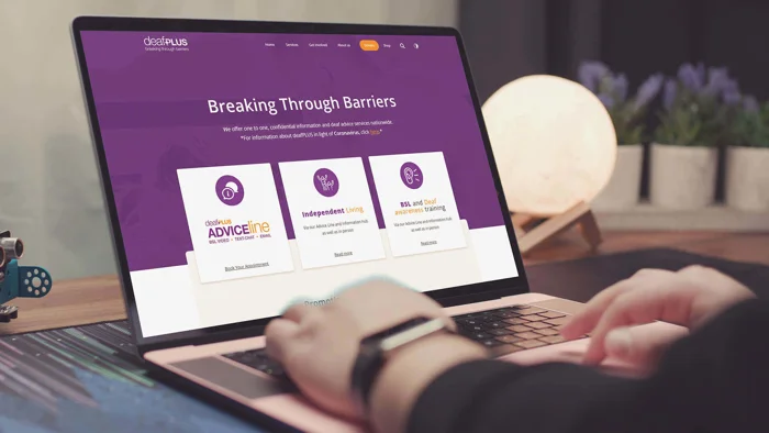 deafPLUS website on laptop