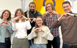 Team members making heart symbol for International Womens Day, supporting women in tech