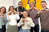 Team members making heart symbol for International Womens Day, supporting women in tech