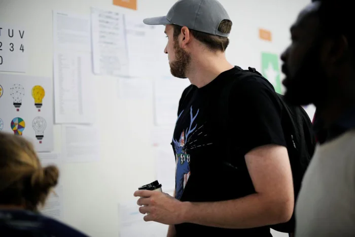 Man looking at board to visualise design thinking