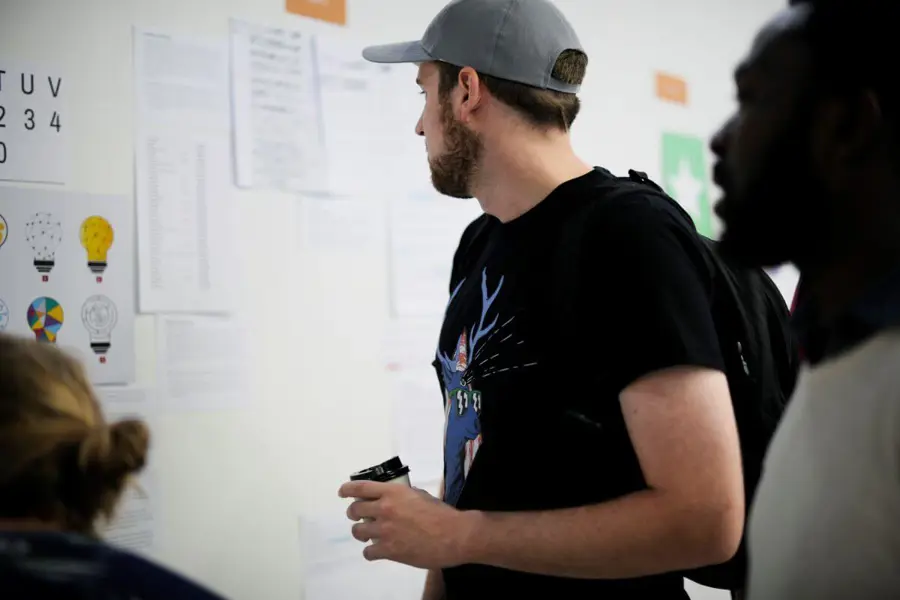 Man looking at board to visualise design thinking