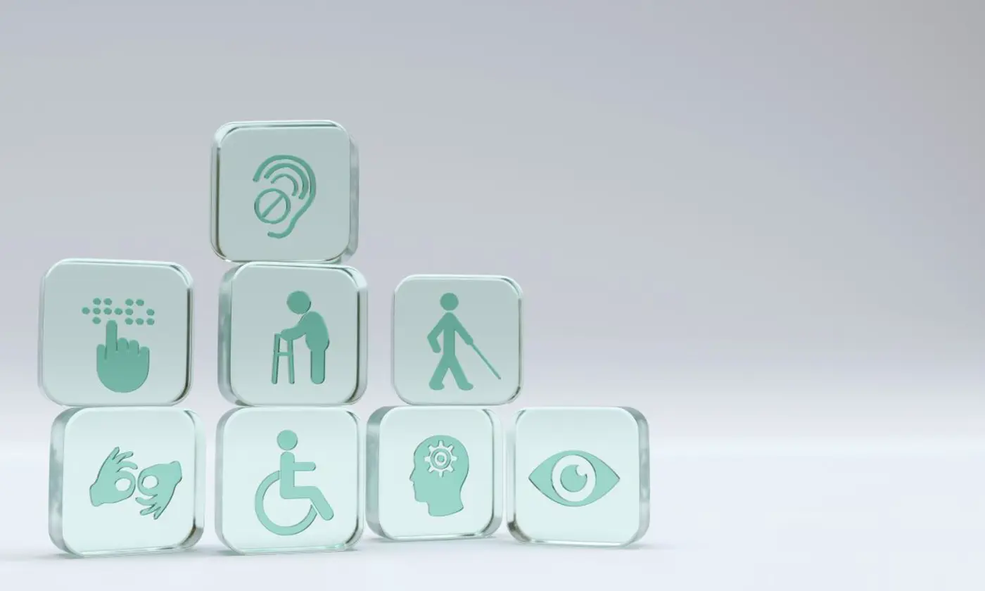 Square glass cubes with symbols for different types of disabilities impacted by accessibility.