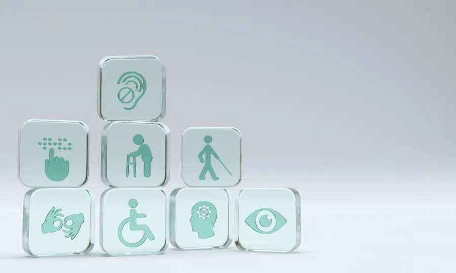 Square glass cubes with symbols for different types of disabilities impacted by accessibility.